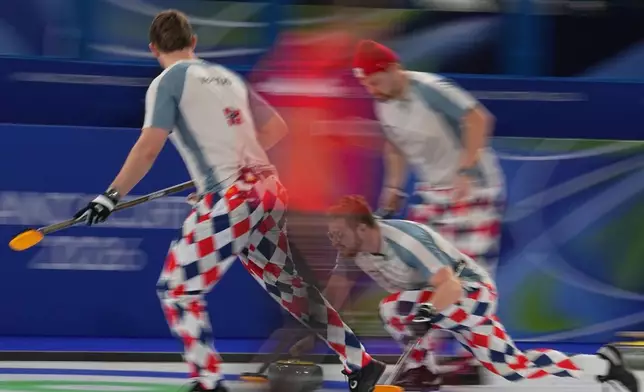 Norway's Martin Sesaker, Bendik Ramsfjell, Gaute Nepstad in action during the men's curling round robin session against Sweden at the 2026 Winter Olympics, in Cortina d'Ampezzo, Italy, Tuesday, Feb. 17, 2026. (AP Photo/Fatima Shbair)