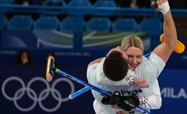 United States' Cory Thiesse and Korey Dropkin hug during the mixed doubles round robin phase of the curling competition against Sweden, at the 2026 Winter Olympics, in Cortina d'Ampezzo, Italy, Sunday, Feb. 8, 2026. (AP Photo/Misper Apawu)