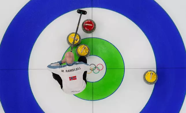 Norway's Magnus Ramsfjell looks over the stones during a men's curling round robin match against China at the 2026 Winter Olympics, in Cortina d'Ampezzo, Italy, Friday, Feb. 13, 2026. (AP Photo/David J. Phillip)
