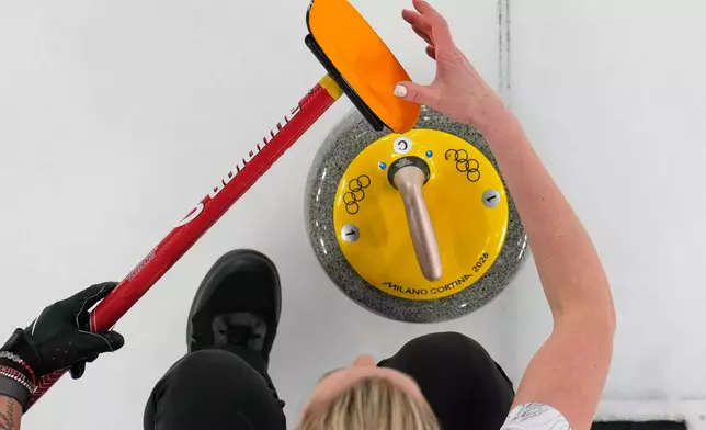 Canada's Emma Miskew prepares to deliver the stone during a women's curling round robin match against China at the 2026 Winter Olympics, in Cortina d'Ampezzo, Italy, Monday, Feb. 16, 2026. (AP Photo/David J. Phillip)