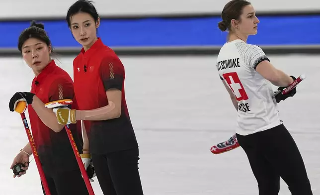 China's Dong Ziqi, Jiang Jiayi and Switzerland's Selina Witschonke compete during the women's curling round robin session at the 2026 Winter Olympics, in Cortina d'Ampezzo, Italy, Monday, Feb. 16, 2026. (AP Photo/Fatima Shbair)