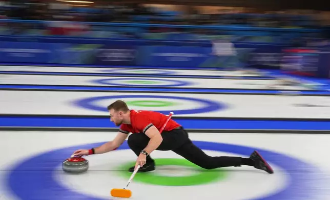 Switzerland's Yannick Schwaller in action during the mixed doubles round robin phase of the curling competition against Canada, at the 2026 Winter Olympics, in Cortina d'Ampezzo, Italy, Monday, Feb. 9, 2026. (AP Photo/Fatima Shbair)