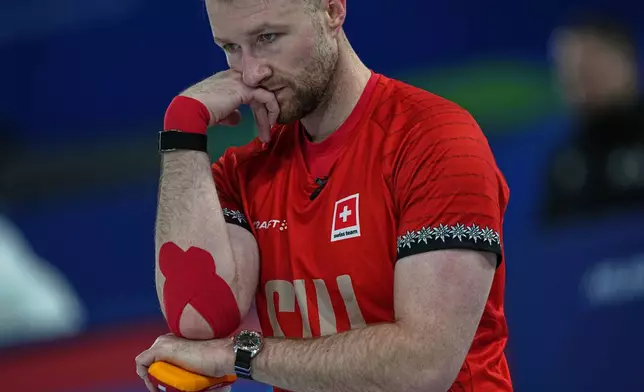 Switzerland's Yannick Schwaller competes during the mixed doubles round robin phase of the curling competition against Canada at the 2026 Winter Olympics, in Cortina d'Ampezzo, Italy, Monday, Feb. 9, 2026. (AP Photo/Fatima Shbair)