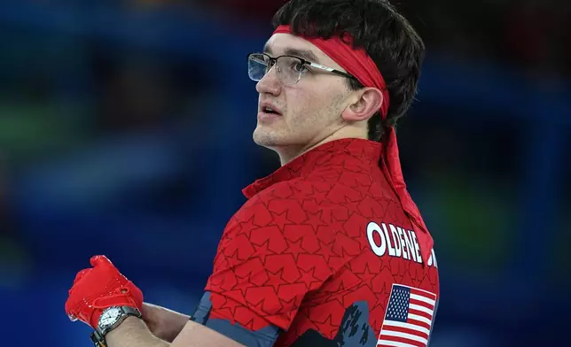 United States' Aidan Oldenburg in action during the men's curling round robin session against Switzerland, at the 2026 Winter Olympics, in Cortina d'Ampezzo, Italy, Thursday, Feb. 12, 2026. (AP Photo/Fatima Shbair)