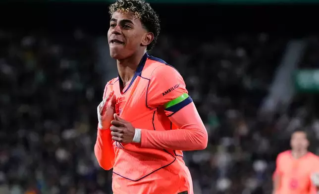 Barcelona's Lamine Yamal celebrates after scoring the opening goal with his teammate Barcelona's Raphinha during a Spanish La Liga soccer match between Elche and Barcelona in Elche, Spain, Saturday, Jan. 31, 2026. (AP Photo/Jose Breton)