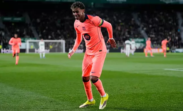 Barcelona's Lamine Yamal celebrates after scoring the opening goal with his teammate Barcelona's Raphinha during a Spanish La Liga soccer match between Elche and Barcelona in Elche, Spain, Saturday, Jan. 31, 2026. (AP Photo/Jose Breton)
