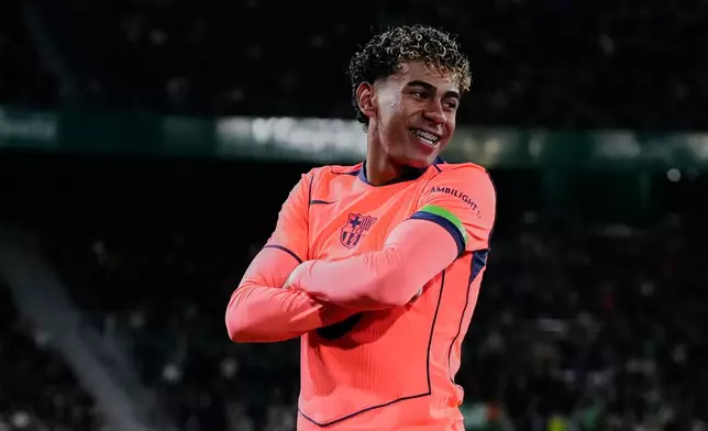 Barcelona's Lamine Yamal celebrates after scoring the opening goal with his teammate Barcelona's Raphinha during a Spanish La Liga soccer match between Elche and Barcelona in Elche, Spain, Saturday, Jan. 31, 2026. (AP Photo/Jose Breton)