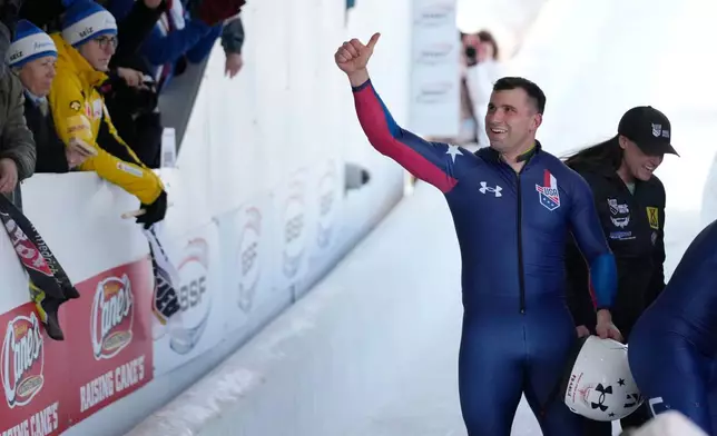 FILE -Frank del Duca, pilot of the fourth-place United States team, waves to fans after the 4-man bobsled event at the bobsled world championships, March 15, 2025, in Lake Placid, N.Y. (AP Photo/Seth Wenig, File)
