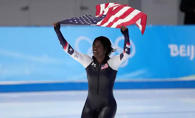 FILE - Erin Jackson of the United States hoists an American flag after winning the gold medal in the speedskating women's 500-meter race at the 2022 Winter Olympics, Sunday, Feb. 13, 2022, in Beijing. (AP Photo/Sue Ogrocki, file)