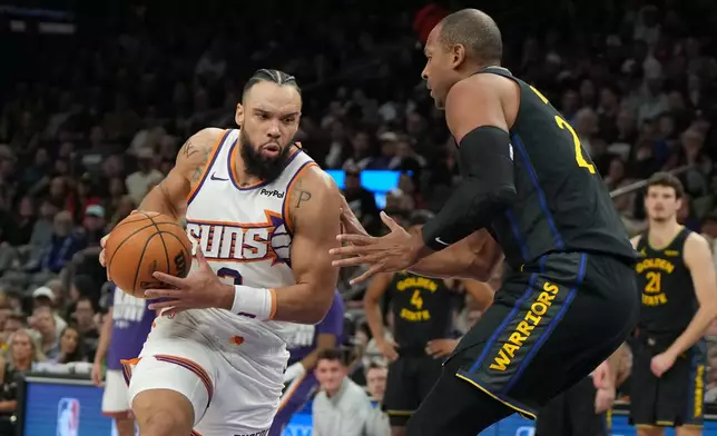 Phoenix Suns forward Dillon Brooks drives on Golden State Warriors center Al Horford (20) during the first half of an NBA basketball game, Thursday, Feb. 5, 2026, in Phoenix. (AP Photo/Rick Scuteri)