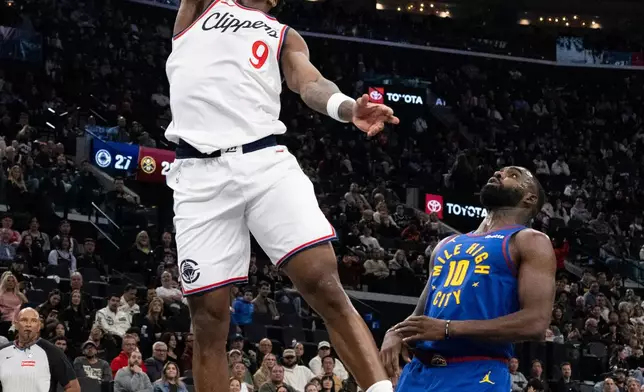 Los Angeles Clippers guard Bennedict Mathurin (9) dunks past Denver Nuggets guard Tim Hardaway Jr. (10) during the first half of an NBA basketball game Thursday, Feb. 19, 2026, in Inglewood, Calif. (AP Photo/Kyusung Gong)
