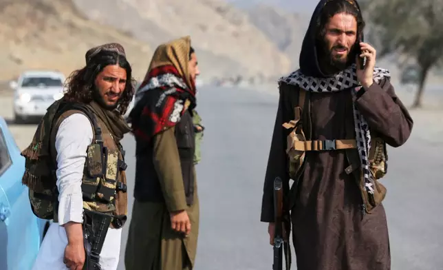 Afghan Taliban soldiers stand on the Afghan side of the Torkham border crossing with Pakistan in Torkham, Afghanistan, Friday, Feb. 27, 2026. (AP Photo/Wahidullah Kakar)
