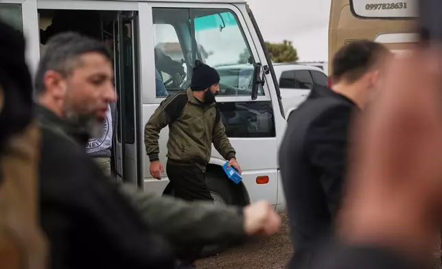 A Druze prisoner get off a minibus after his release in a prisoner exchange between Syrian government forces and Druze militiamen in Sweida province, Syria, Thursday, Feb. 26, 2026. (AP Photo/Ghaith Alsayed)