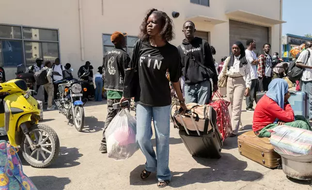 Students carry their belongings as they leave the Cheikh Anta Diop University, which is being evacuated following the death of second year student Abdoulaye Ba, in Dakar Tuesday, Feb. 10, 2026. (AP Photo/Sylvain Cherkaoui)