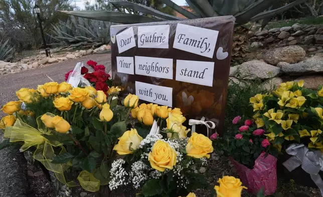 A small vigil grows near Nancy Guthrie's house, Wednesday, Feb. 11, 2026 in Tucson, Ariz. (AP Photo/Ty ONeil)