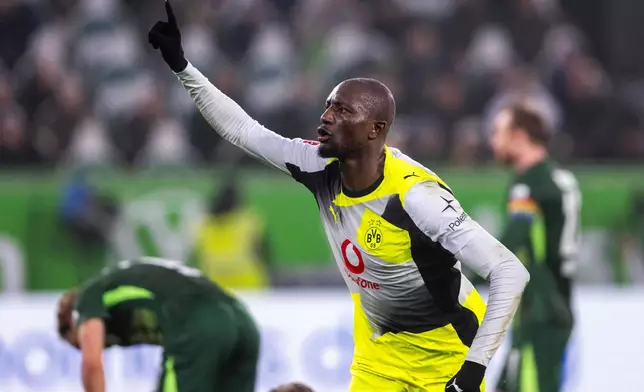 Dortmund's Serhou Guirassy celebrates after scoring their side's second goal of the game during the German Bundesliga soccer match between Wolfsburg and Borussia Dortmund, in Wolfsburg, Germany, Saturday, Feb. 7, 2026. (David Inderlied/dpa via AP)