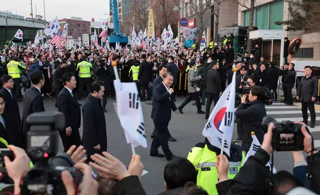 FILE - Impeached South Korean President Yoon Suk Yeol, center, greets his supporters upon his arrival outside of presidential residence in Seoul, South Korea, on March 8, 2025. (Kim In-chul/Yonhap via AP)