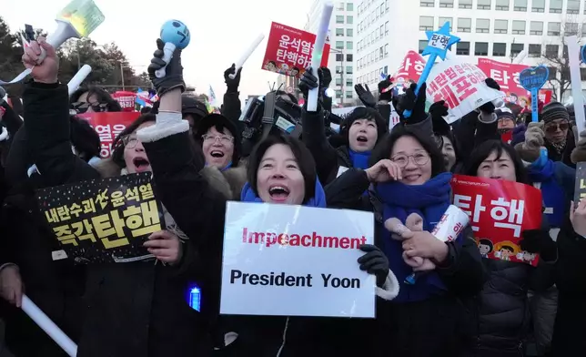 FILE - Participants react after hearing the news that South Korea's parliament voted to impeach President Yoon Suk Yeol outside the National Assembly in Seoul, South Korea, on Dec. 14, 2024. (AP Photo/Lee Jin-man, File)