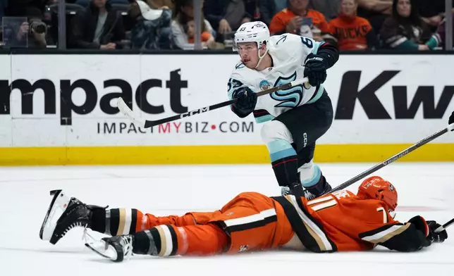 Anaheim Ducks defenseman Ian Moore (74) blocks the shot by Seattle Kraken right wing Jacob Melanson (63) during the second period of an NHL hockey game, Tuesday, Feb. 3, 2026, in Anaheim, Calif. (AP Photo/Kyusung Gong)