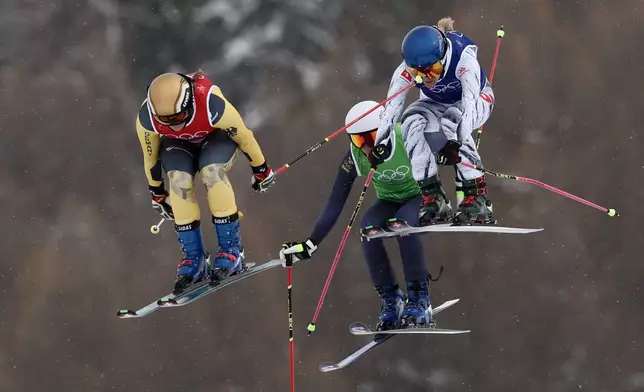 From left, Germany's Daniela Maier (1), Sweden's Sandra Naeslund (2) and Switzerland's Fanny Smith (3) compete during the women's ski cross finals at the 2026 Winter Olympics, in Livigno, Italy, Friday, Feb. 20, 2026. (AP Photo/Gabriele Facciotti)