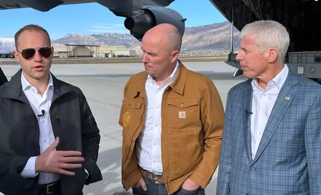 Isaiah Taylor, CEO of Valar Atomics, left, speaks as Utah Gov. Spencer Cox, center, and Energy Secretary Chris Wright, listen, at Hill Air Force Base, Utah, Sunday, Feb. 15, 2026. (AP Photo/Matthew Daly)
