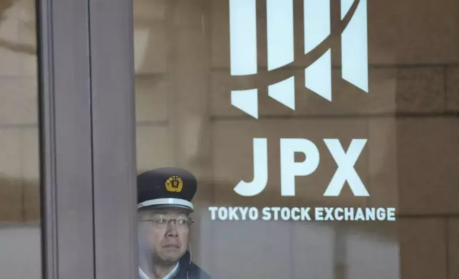 A security guard stands guard at the gate of Tokyo Stock Exchange building, Monday, Feb. 9, 2026, in Tokyo. (AP Photo/Eugene Hoshiko)