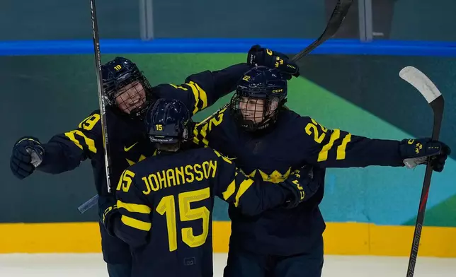 Sweden's Hanna Thuvik, right, celebrates after scoring her side's opening goal during a preliminary round match of women's ice hockey between Japan and Sweden at the 2026 Winter Olympics, in Milan, Italy, Tuesday, Feb. 10, 2026. (AP Photo/Hassan Ammar)