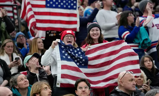 US supporters cheer during a preliminary round match of women's ice hockey between USA and Canada at the 2026 Winter Olympics, in Milan, Italy, Tuesday, Feb. 10, 2026. (AP Photo/Petr David Josek)