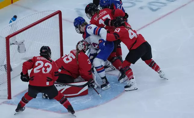 United States' Kirsten Simms scores her side's third goal during a preliminary round match of women's ice hockey between USA and Canada at the 2026 Winter Olympics, in Milan, Italy, Tuesday, Feb. 10, 2026. (AP Photo/Antonio Calanni)