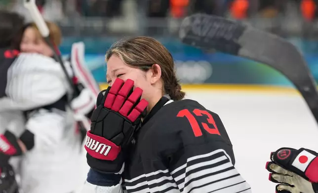 Japan's Yumeka Wajima cries end of a preliminary round match of women's ice hockey between Japan and Sweden at the 2026 Winter Olympics, in Milan, Italy, Tuesday, Feb. 10, 2026. (AP Photo/Hassan Ammar)