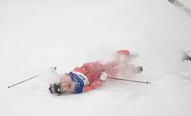 Ukraine's Kateryna Kotsar crashes as she competes in the women's freestyle skiing big air qualifications at the 2026 Winter Olympics, in Livigno, Italy, Saturday, Feb. 14, 2026. (AP Photo/Abbie Parr)