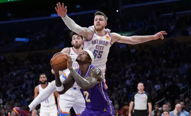 Los Angeles Lakers forward Jarred Vanderbilt (2) looks to shoot under pressure by Oklahoma City Thunder center Isaiah Hartenstein (55) during the first half of an NBA basketball game Monday, Feb. 9, 2026, in Los Angeles. (AP Photo/Jae C. Hong)