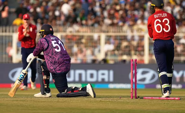 Scotland's Mark Watt is bowled out by England's Adil Rashid during the T20 World Cup cricket match between England and Scotland in Kolkata, India, Saturday, Feb. 14, 2026. (AP Photo/Bikas Das)
