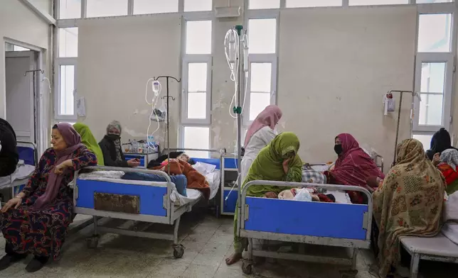 Afghan women care for their children in the malnutrition ward at Indira Gandhi Children's Hospital in Kabul, Afghanistan, Sunday, Feb. 15, 2026. (AP Photo/Siddiqullah Alizai)