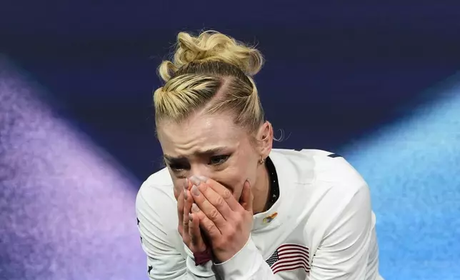 Amber Glenn of the United States reacts to her score after competing in the women's short program in figure skating at the 2026 Winter Olympics, in Milan, Italy, Tuesday, Feb. 17, 2026. (AP Photo/Natacha Pisarenko)