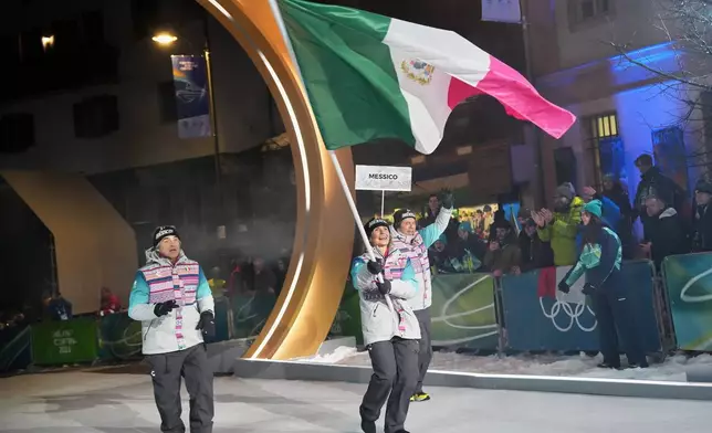 Team Mexico flag bearer Sarah Schleper arrives for the Olympic opening ceremony at the 2026 Winter Olympics, in Cortina d'Ampezzo, Italy, Friday, Feb. 6, 2026. (AP Photo/Misper Apawu)