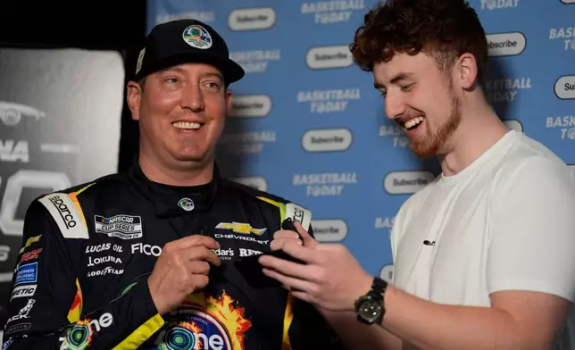 Kyle Busch speaks with Justin Leusner about basketball trivia for his Basketball Today YouTube channel during a NASCAR Daytona 500 media day, Wednesday, Feb. 11, 2026, in Daytona, Fla. (AP Photo/Mike Stewart)