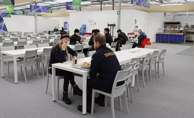 Members of Team Sweden eat at the main dining hall at the Cortina Olympic Village, ahead of the 2026 Winter Olympics, in Cortina d'Ampezzo, Italy, Tuesday, Feb. 3, 2026. (AP Photo/Jennifer McDermott)