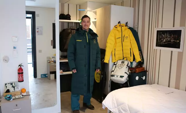 Nick Timmings, who is competing in the skeleton for Australia, poses for a photo in his room at the Cortina Olympic Village, ahead of the 2026 Winter Olympics, in Cortina d'Ampezzo, Italy, Tuesday, Feb. 3, 2026. (AP Photo/Jennifer McDermott)