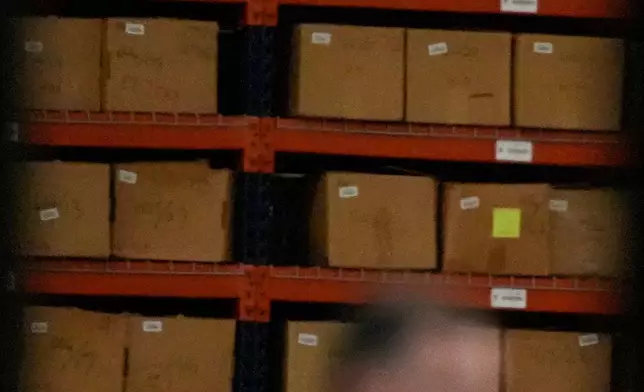 An FBI employee stands inside the Fulton County Election HUB as the FBI takes Fulton County 2020 Election ballots, Wednesday, Jan. 28, 2026, in Union City, Ga., near Atlanta. (AP Photo/Mike Stewart)