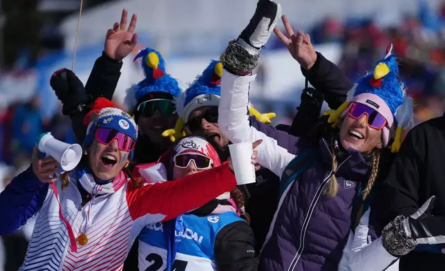 Fans of France wait for the start of the men's 15-kilometer mass start biathlon race at the 2026 Winter Olympics in Anterselva, Italy, Friday, Feb. 20, 2026. (AP Photo/Andrew Medichini)