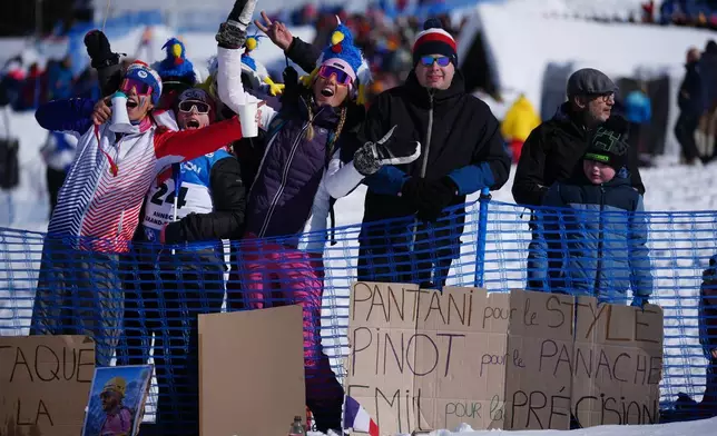 Fans of France wait for the start of the men's 15-kilometer mass start biathlon race at the 2026 Winter Olympics in Anterselva, Italy, Friday, Feb. 20, 2026. (AP Photo/Andrew Medichini)