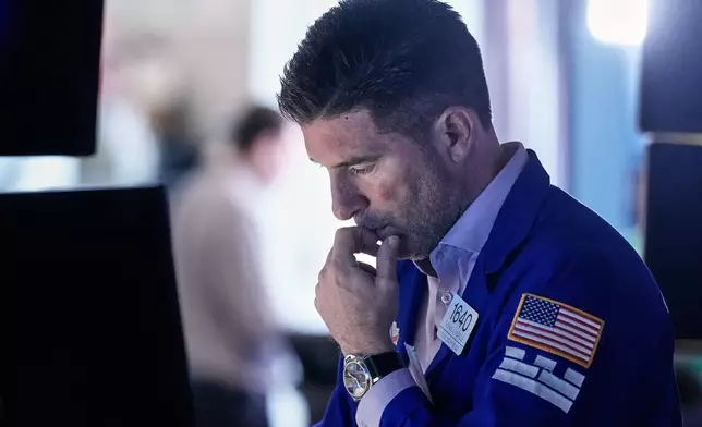 Specialist Thomas McArdle works at his post on the floor of the New York Stock Exchange, Friday, Feb. 20, 2026. (AP Photo/Richard Drew)