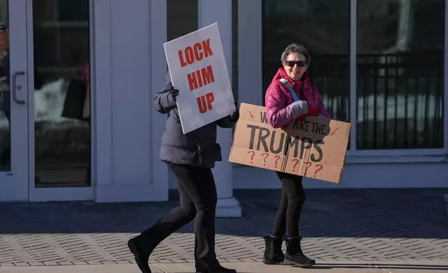 Demonstrators walk around outside the Chappaqua Performing Arts Center while awaiting the arrival of former President Bill Clinton who is testifying before U.S. House lawmakers as part of a congressional investigation into convicted sex offender Jeffrey Epstein, , Friday, Feb. 27, 2026, in Chappaqua, N.Y. (AP Photo/Angelina Katsanis)