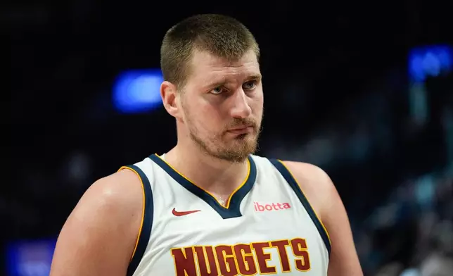 Denver Nuggets center Nikola Jokić looks on during the first half of an NBA basketball game against the Portland Trail Blazers, Friday, Feb. 20, 2026, in Portland, Ore. (AP Photo/Jenny Kane)
