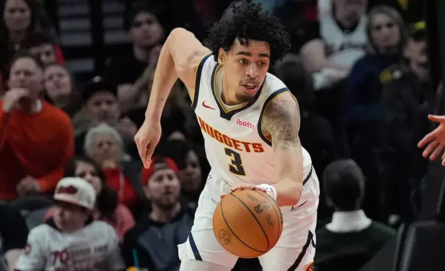 Denver Nuggets guard Julian Strawther (3) goes for the ball during the first half of an NBA basketball game against the Portland Trail Blazers, Friday, Feb. 20, 2026, in Portland, Ore. (AP Photo/Jenny Kane)
