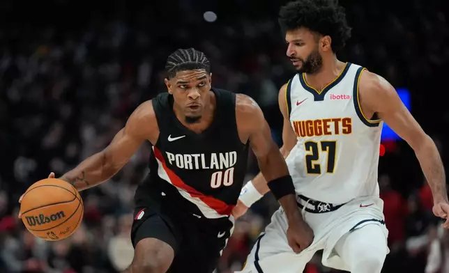 Portland Trail Blazers guard Scoot Henderson (00) drives to the basket as Denver Nuggets guard Jamal Murray (27) defends during the first half of an NBA basketball game Friday, Feb. 20, 2026, in Portland, Ore. (AP Photo/Jenny Kane)