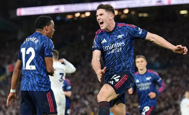 Arsenal's Viktor Gyokeres, right, celebrates scoring his side's third goal of the game with team-mate Jurrien Timber during the English Premier League soccer match between Leeds United and Arsenal in Leeds, England, Saturday, Jan. 31, 2026. (Mike Egerton/PA via AP)