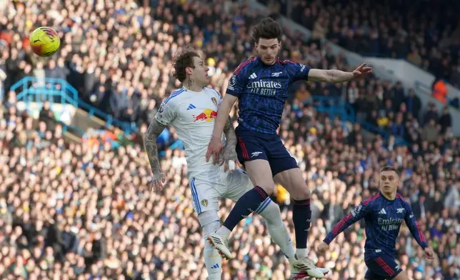 Leeds' Joe Rodon, left, and Arsenal's Declan Rice challenge for the ball during the English Premier League soccer match between Leeds United and Arsenal in Leeds, England, Saturday, Jan. 31, 2026. (AP Photo/Ian Hodgson)