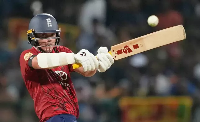 England's Sam Curran plays a shot during the third T20 cricket match between England and Sri Lanka in Pallekele, Sri Lanka, Tuesday, Feb, 3. 2026. (AP Photo/Eranga Jayawardena)
